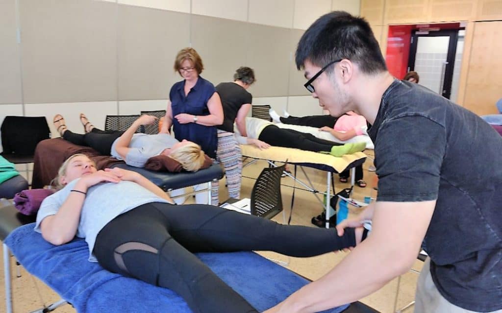 Learning is a team sport at Genesis. Jen Li Sheng, Genesis Center Manager practicing his treatment techniques at Paula Nutting's class